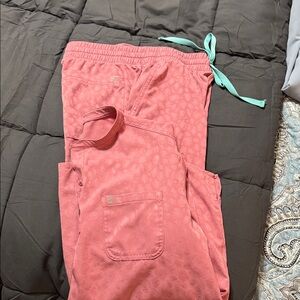 Women’s pink Scrub set with animal print design.